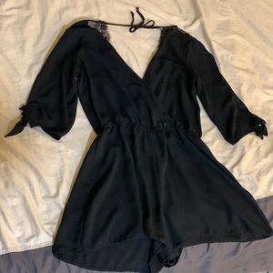 Black bebop short romper with lace on the upper back area.